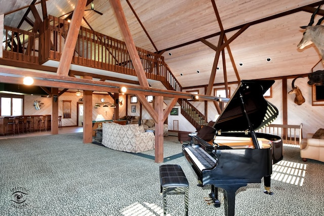 miscellaneous room featuring beamed ceiling, high vaulted ceiling, wood ceiling, and wood walls