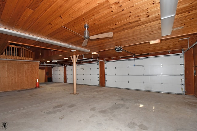 garage featuring a garage door opener, ceiling fan, and wooden ceiling