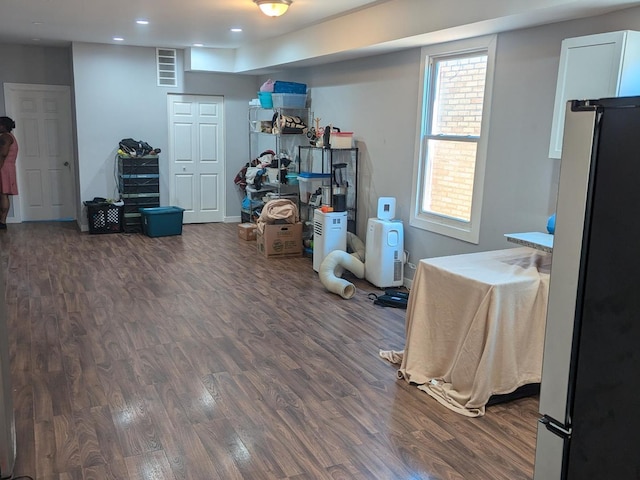 interior space with stainless steel refrigerator and dark hardwood / wood-style floors