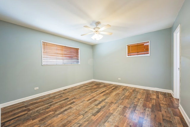 unfurnished room with dark wood-type flooring and ceiling fan