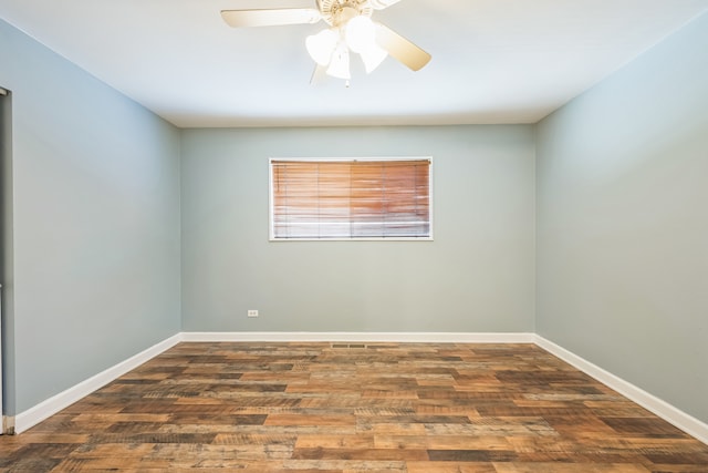 unfurnished room featuring dark wood-type flooring and ceiling fan