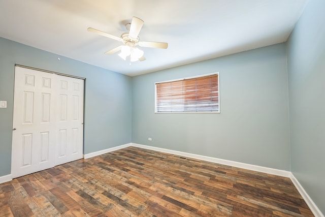 unfurnished bedroom featuring a closet, ceiling fan, and dark hardwood / wood-style flooring