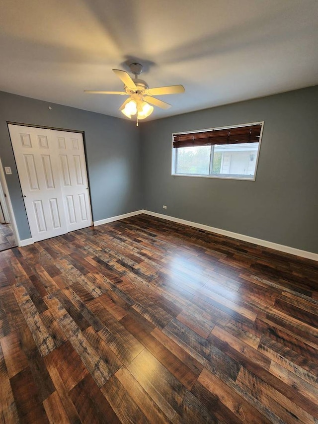 unfurnished bedroom with ceiling fan and dark hardwood / wood-style flooring