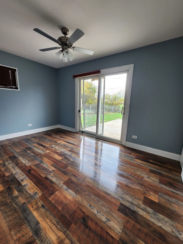 spare room with ceiling fan and dark hardwood / wood-style floors