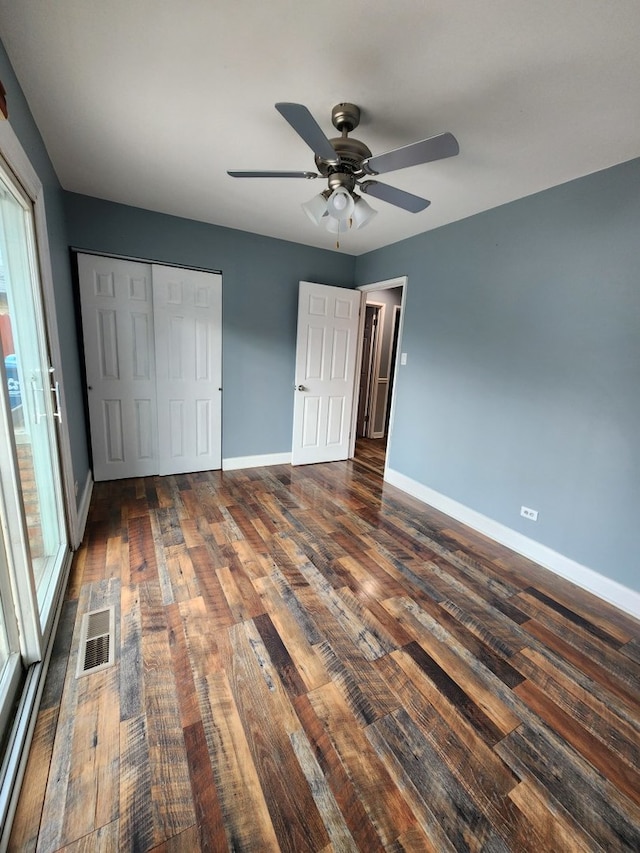 unfurnished bedroom with a closet, ceiling fan, and dark hardwood / wood-style flooring