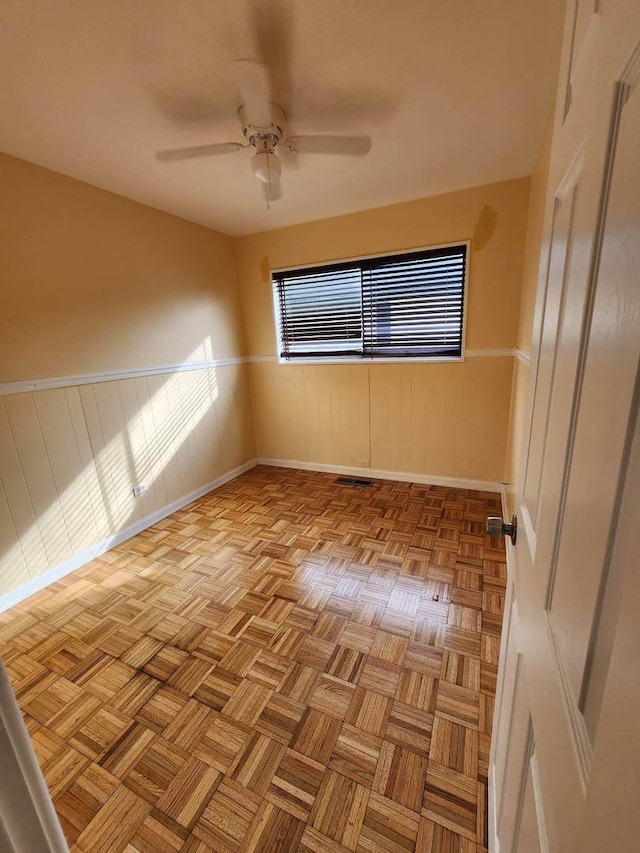 unfurnished room featuring ceiling fan and light parquet flooring