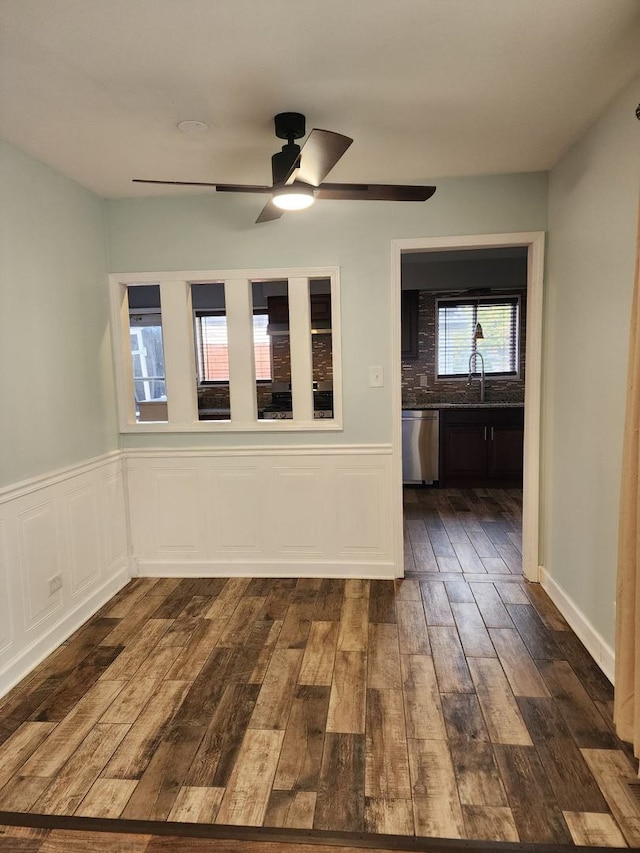 spare room featuring sink, ceiling fan, and dark hardwood / wood-style flooring