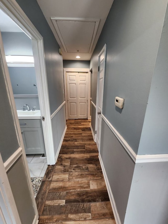 hallway featuring sink and dark hardwood / wood-style floors