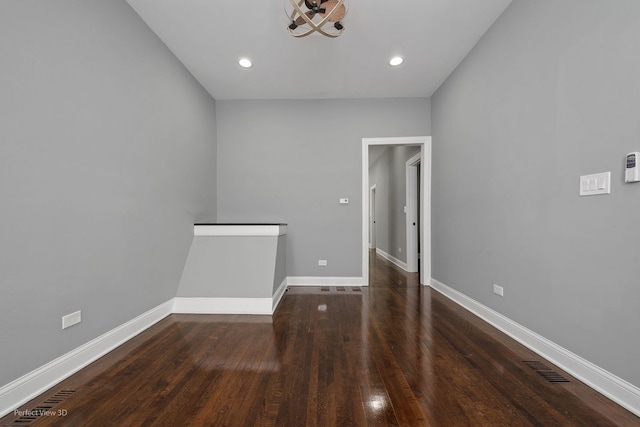 empty room featuring dark wood-type flooring