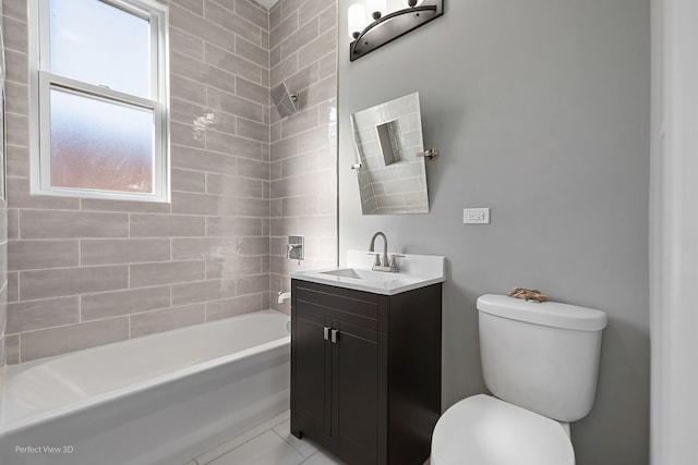 full bathroom featuring vanity, toilet, tiled shower / bath combo, and tile patterned flooring