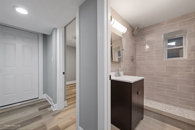 bathroom with vanity, a shower, and hardwood / wood-style floors