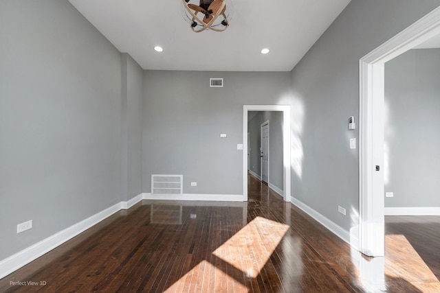 unfurnished room featuring dark wood-type flooring