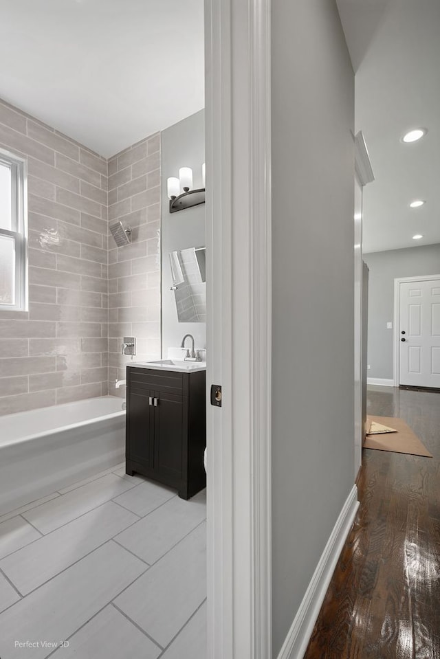 bathroom with shower / bathing tub combination, vanity, and wood-type flooring