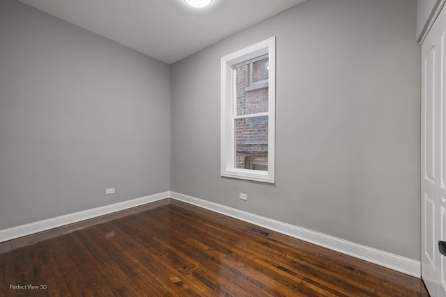 empty room with hardwood / wood-style flooring