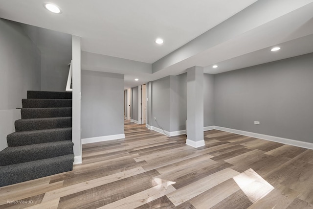 basement with light hardwood / wood-style flooring