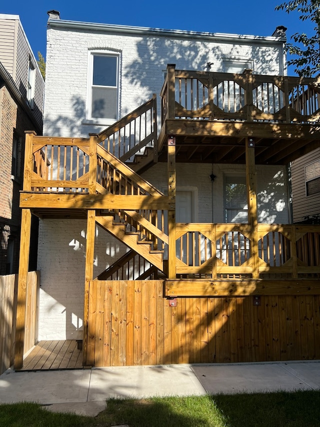 back of house with a deck