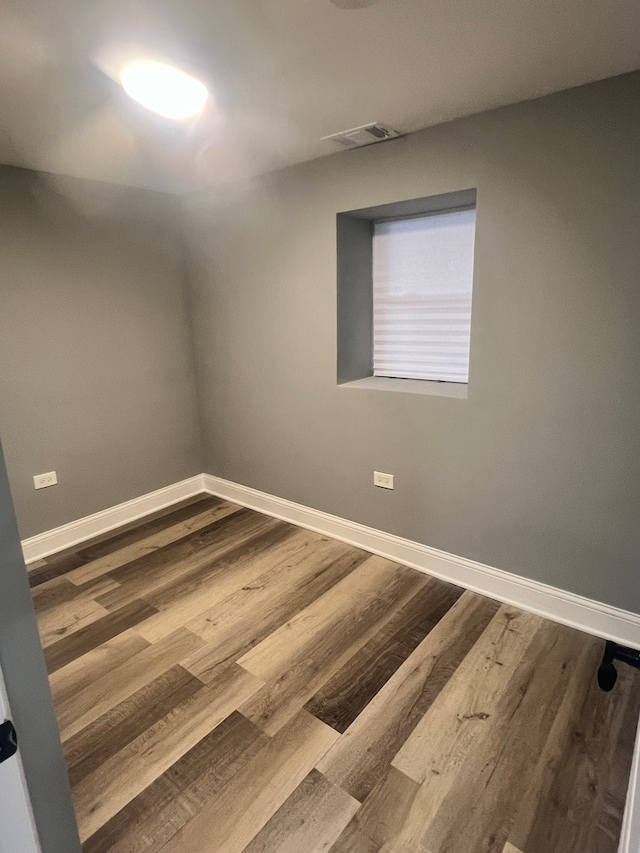 spare room with wood-type flooring