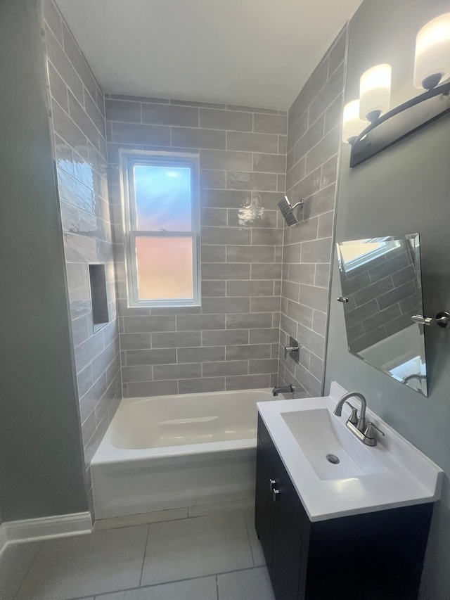 bathroom featuring vanity, tiled shower / bath combo, and tile patterned flooring