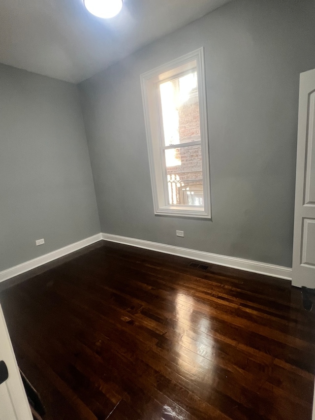 empty room featuring dark wood-type flooring