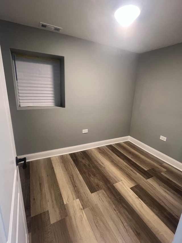 spare room with wood-type flooring