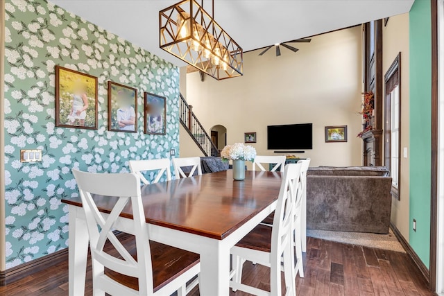 dining space featuring dark wood-type flooring and an inviting chandelier