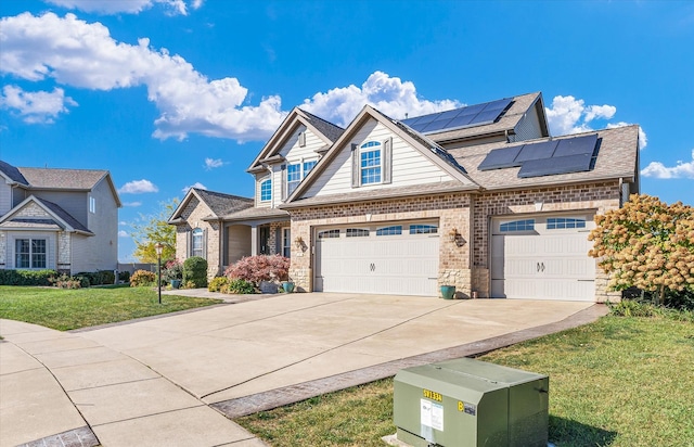 view of front facade with a garage, a front lawn, and solar panels