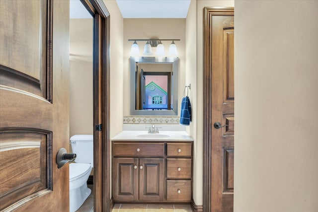 bathroom featuring vanity, toilet, and tile patterned flooring