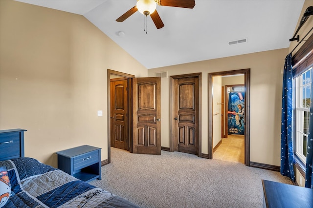 bedroom with vaulted ceiling, light carpet, and ceiling fan