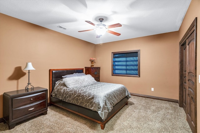 carpeted bedroom featuring a textured ceiling and ceiling fan