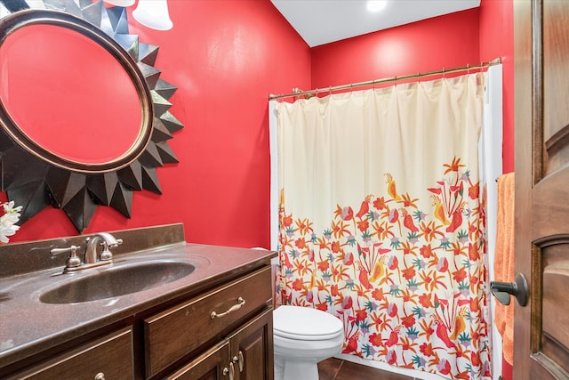 bathroom featuring toilet, a shower with curtain, vanity, and tile patterned floors