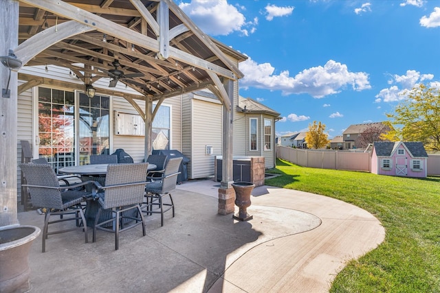 view of patio featuring a storage unit and ceiling fan