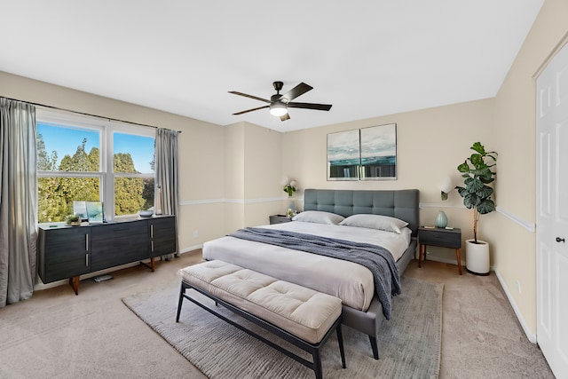 bedroom featuring ceiling fan and light colored carpet