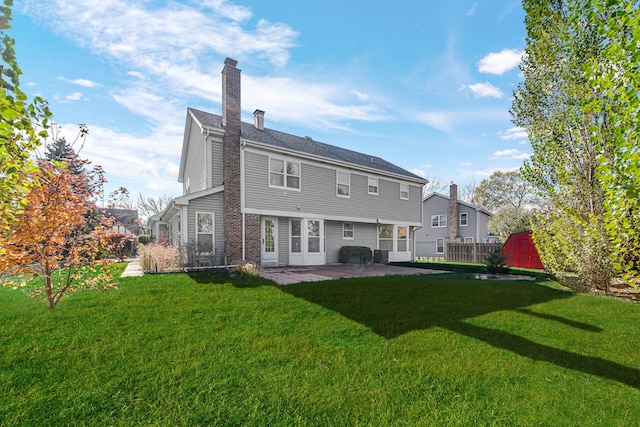 rear view of house featuring a patio and a yard