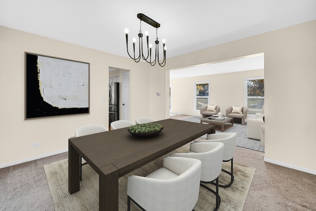 dining area with a notable chandelier and light colored carpet