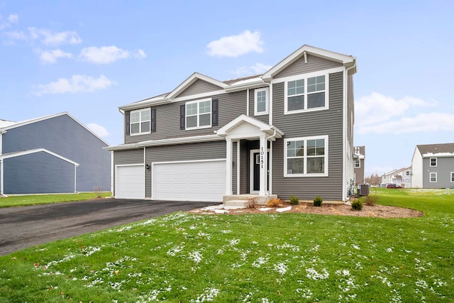 view of front of home featuring central air condition unit, a front yard, and a garage