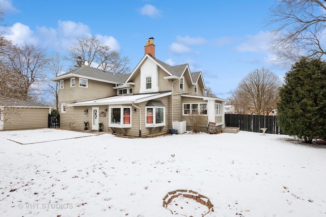 view of snow covered rear of property