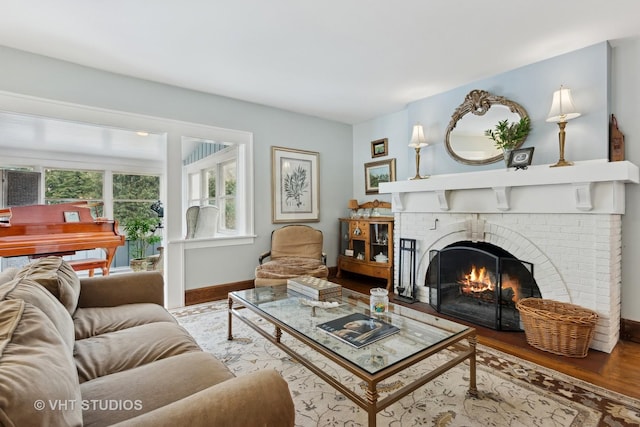 living room featuring hardwood / wood-style floors and a brick fireplace