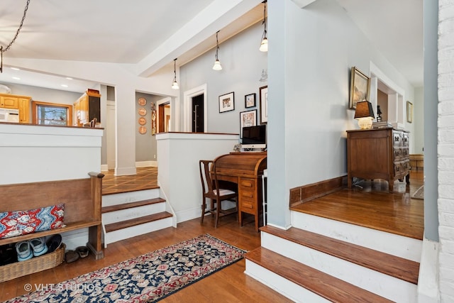 interior space with hardwood / wood-style flooring and vaulted ceiling