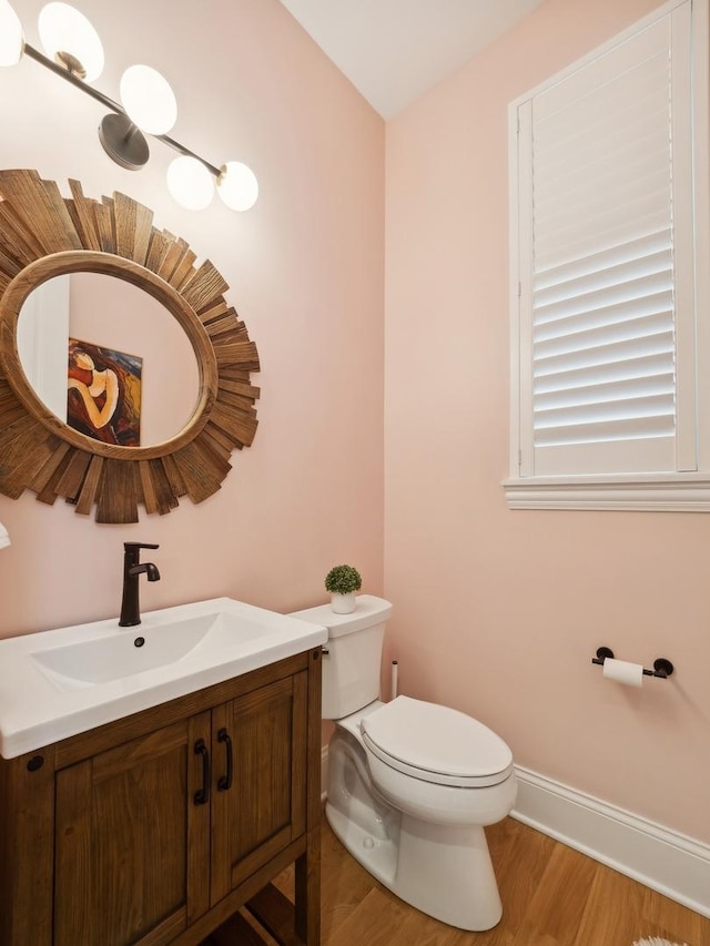 bathroom featuring hardwood / wood-style floors, vanity, and toilet