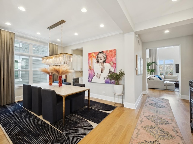 interior space featuring a notable chandelier, crown molding, and light hardwood / wood-style flooring