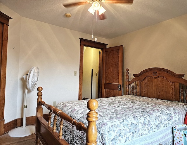 bedroom with hardwood / wood-style floors and ceiling fan