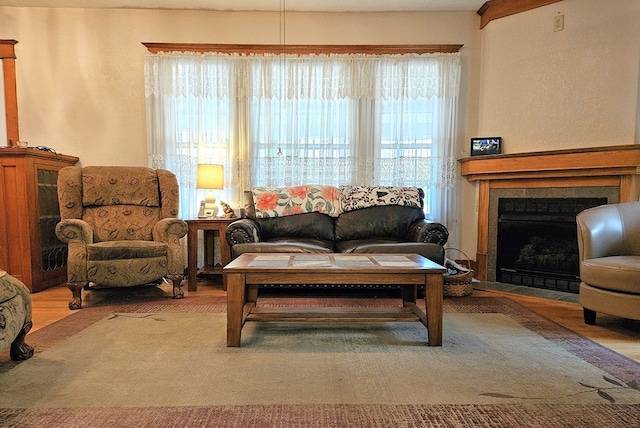 living room with a tile fireplace