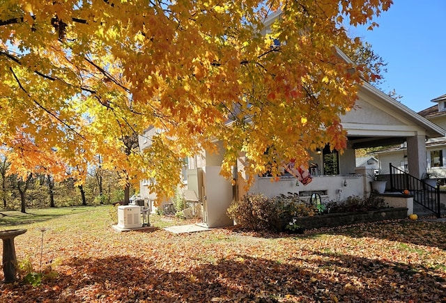 view of side of home with covered porch