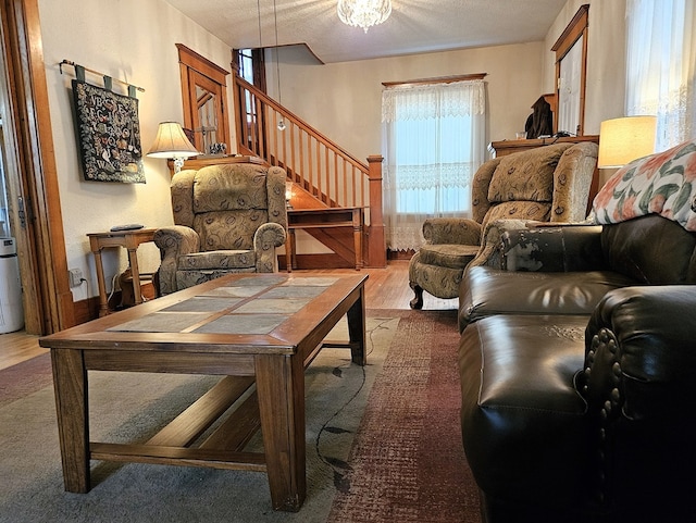 living room with a textured ceiling and hardwood / wood-style flooring