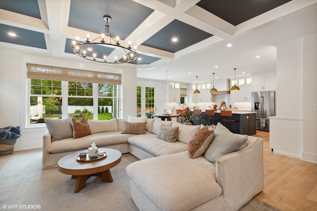 living room featuring beamed ceiling, coffered ceiling, and light wood-type flooring