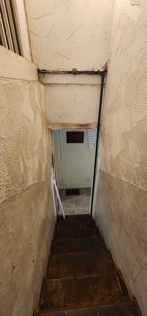 stairway with hardwood / wood-style flooring