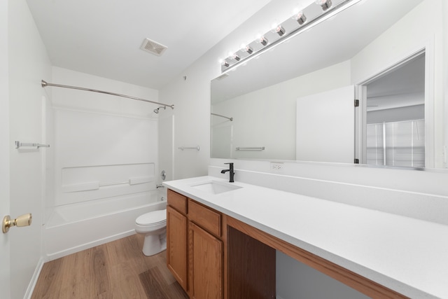 full bathroom featuring vanity, toilet, shower / bath combination, and hardwood / wood-style floors