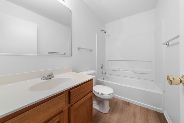 full bathroom featuring vanity, toilet, bathtub / shower combination, and hardwood / wood-style floors