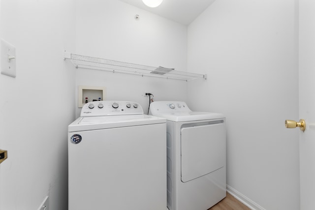 washroom featuring light hardwood / wood-style flooring and independent washer and dryer