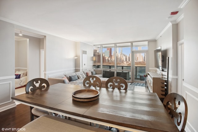 dining room featuring ornamental molding and wood-type flooring